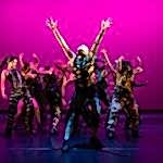 Centre for Advanced Training, dancing group in front of a dramatic magenta backdrop