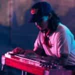 Freshers_Festival_HIGHLIGHTS_24_AF_web-res_APPROVED_21_rgb A student wears a baseball cap and plays a keyboard