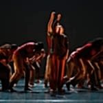 Trinity Laban Youth Dance Company group pose against a dark back drop